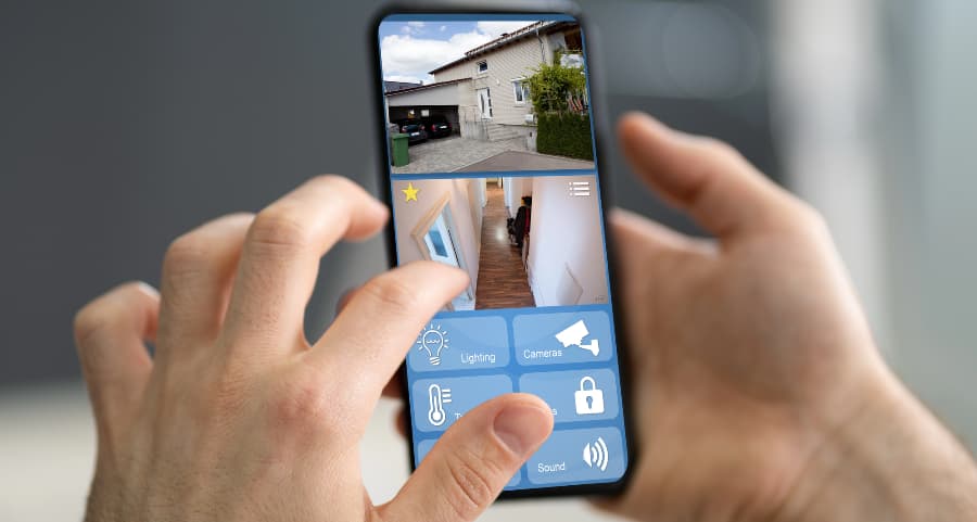 Resident examining surveillance camera feeds on a smartphone